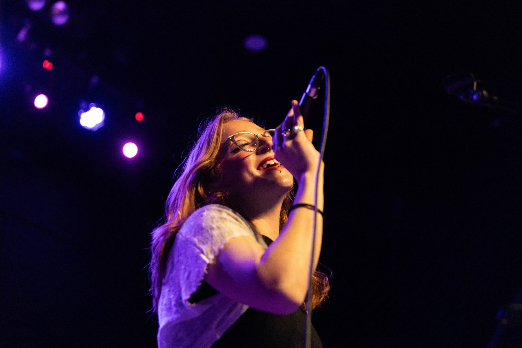 Ana Santiago, voice instructor at Quarter Bend Voice Lessons, performing live on stage