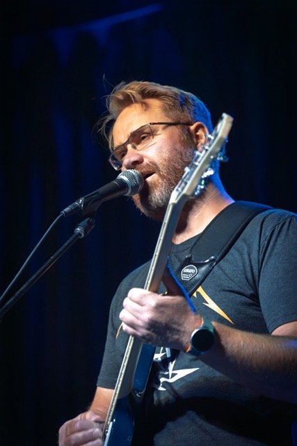 Quarter Bend student Brian performing on stage